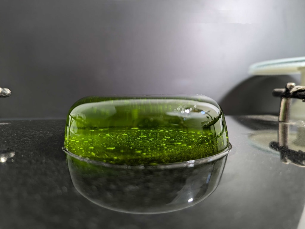 Transparent green jelly soap on black table.  