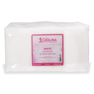 A large, 20-pound solid block of opaque white melt and pour soap tightly wrapped in clear plastic, featuring a pink Essentials by Catalina label.