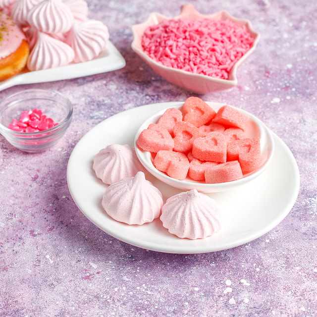 A large, fluffy cone of vibrant pink cotton candy held against a bright white background, illustrating the sweet, airy profile of the fragrance.