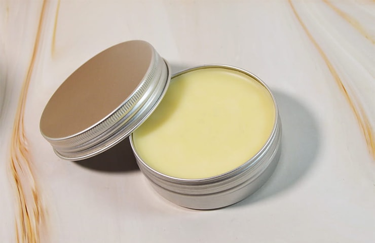 tin of hand salve on a marble background