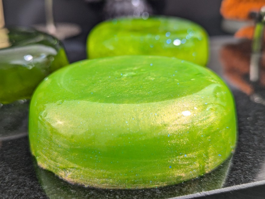 a variety of jelly soap on a black table. 